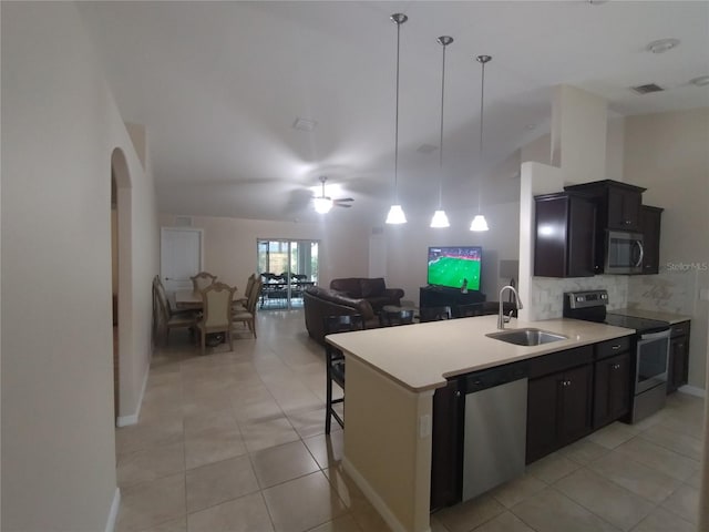 kitchen with visible vents, a sink, decorative backsplash, light countertops, and stainless steel appliances