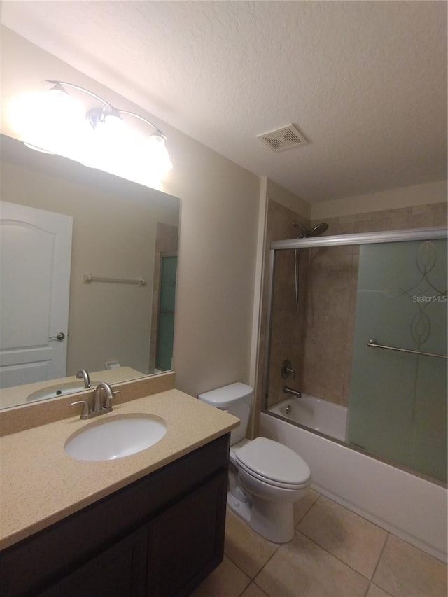 bathroom with vanity, visible vents, a textured ceiling, tile patterned floors, and combined bath / shower with glass door