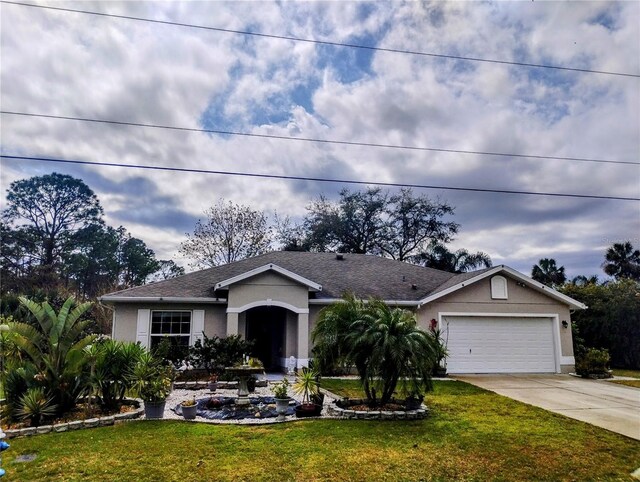 ranch-style home with stucco siding, an attached garage, concrete driveway, and a front yard