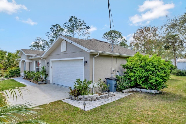 view of side of property featuring stucco siding, an attached garage, concrete driveway, and a lawn