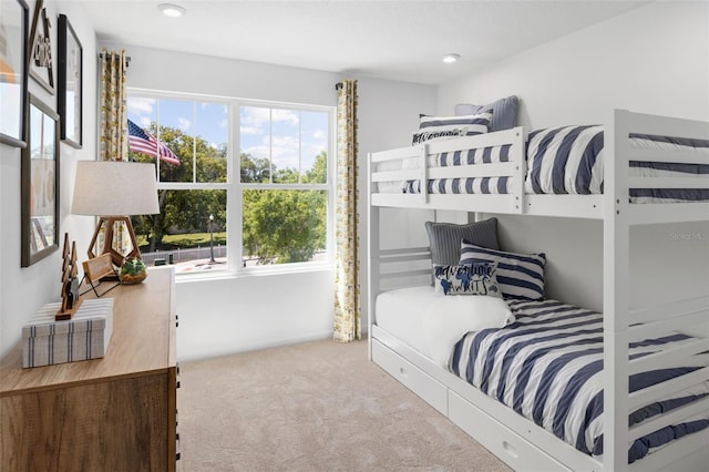 carpeted bedroom with multiple windows