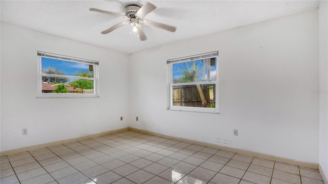 tiled empty room with ceiling fan