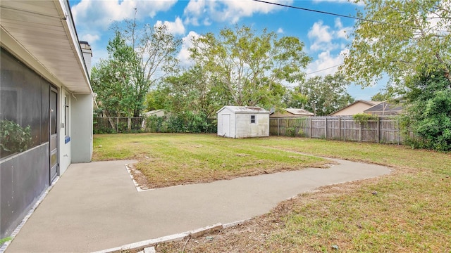 view of yard featuring a storage shed and a patio