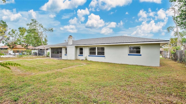 rear view of house with a lawn