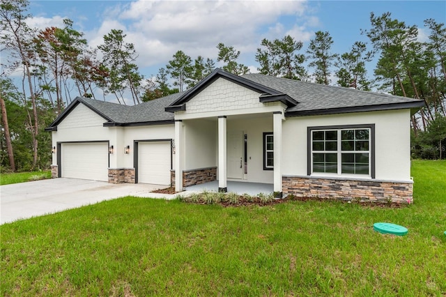 view of front of property featuring a front yard, a porch, and a garage