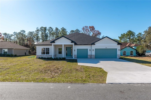 view of front of home featuring a garage and a front yard