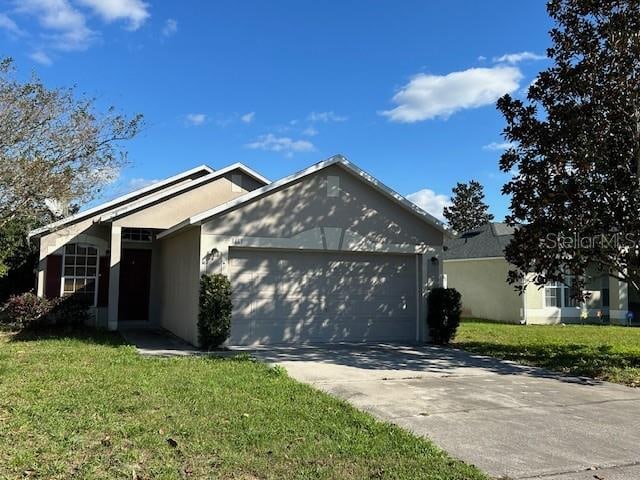 single story home with a garage and a front yard