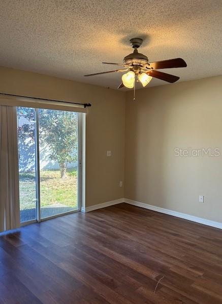 spare room with ceiling fan, dark hardwood / wood-style flooring, and a textured ceiling