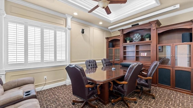 office area with a raised ceiling, ceiling fan, and ornamental molding