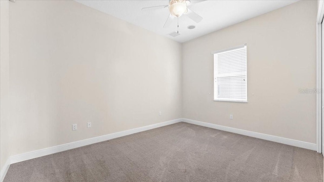 empty room with carpet flooring and ceiling fan