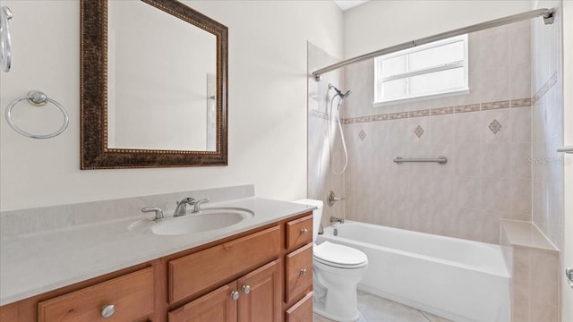 full bathroom with tile patterned floors, vanity, toilet, and tiled shower / bath combo