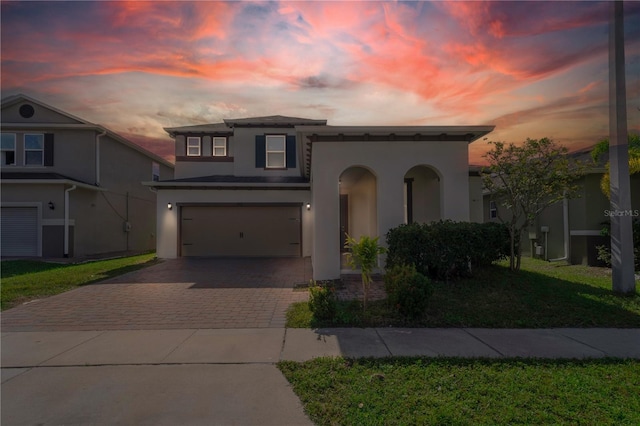 view of front of property with a yard and a garage