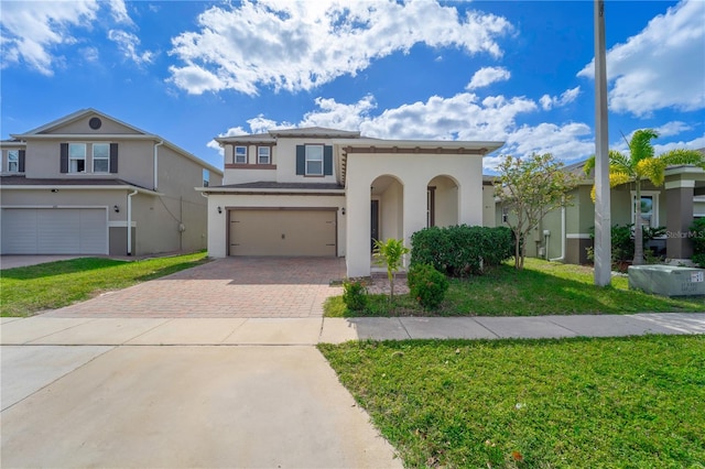 view of front of house with a garage and a front lawn