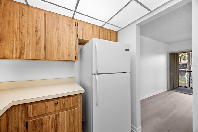 kitchen with light wood-type flooring and white fridge