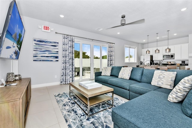 living room featuring ceiling fan, light tile patterned floors, a textured ceiling, and french doors