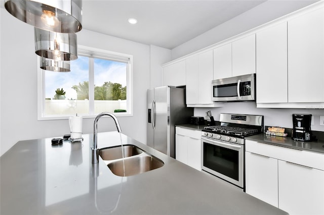 kitchen featuring sink, white cabinets, and appliances with stainless steel finishes