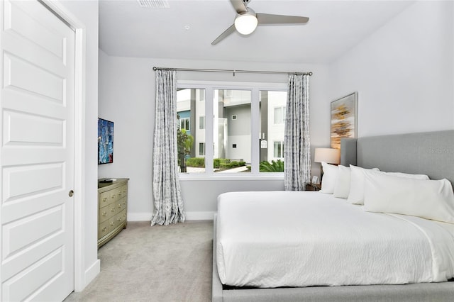 bedroom featuring ceiling fan and light carpet