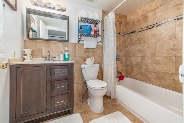 full bathroom featuring tile patterned floors, tile walls, toilet, vanity, and shower / tub combo