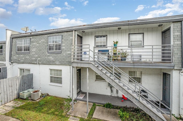 rear view of property featuring cooling unit and a patio