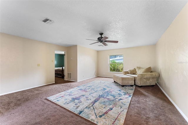 unfurnished room with ceiling fan, carpet floors, and a textured ceiling