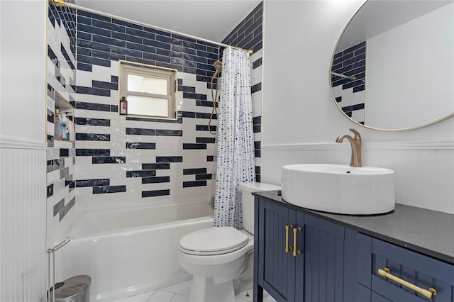 full bathroom featuring vanity, tile patterned floors, wooden walls, toilet, and shower / tub combo