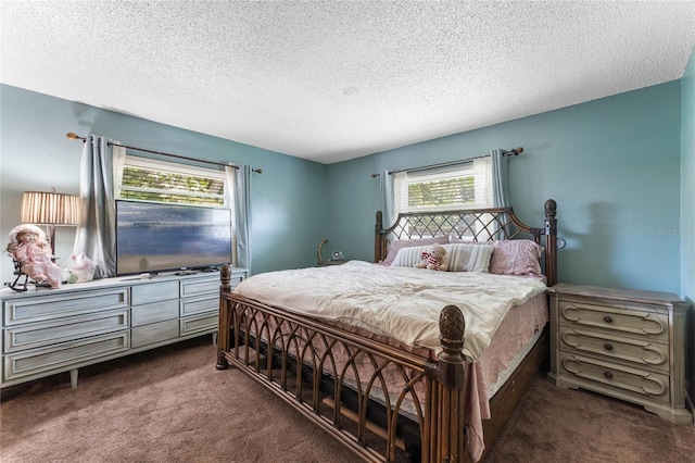 carpeted bedroom featuring a textured ceiling