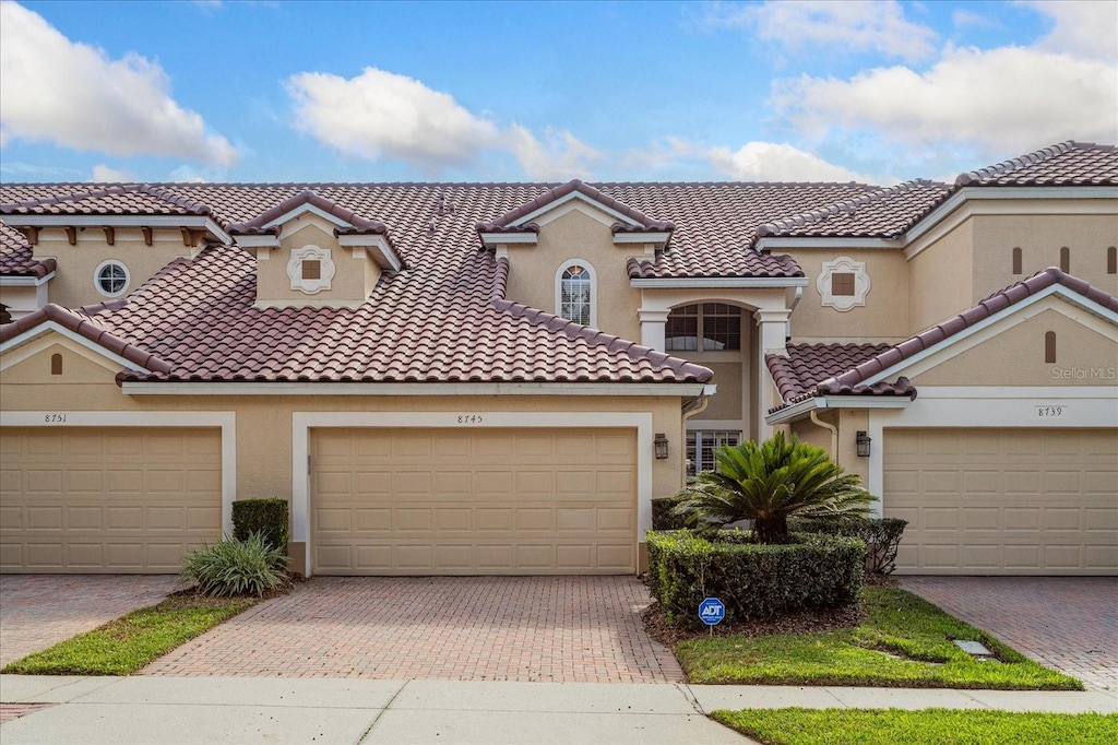 mediterranean / spanish-style house featuring a garage