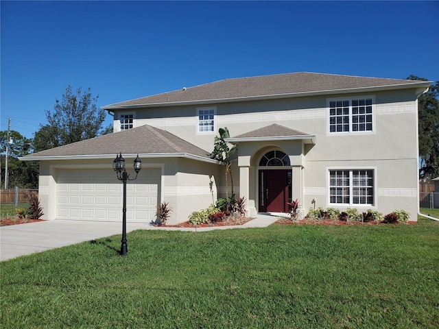 view of front of home with a front yard and a garage