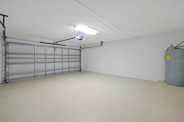 garage featuring electric water heater and a garage door opener