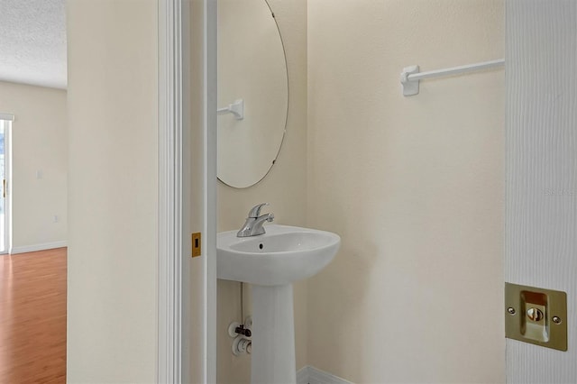 bathroom featuring sink and a textured ceiling