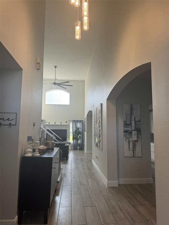 hallway with a high ceiling and dark wood-type flooring