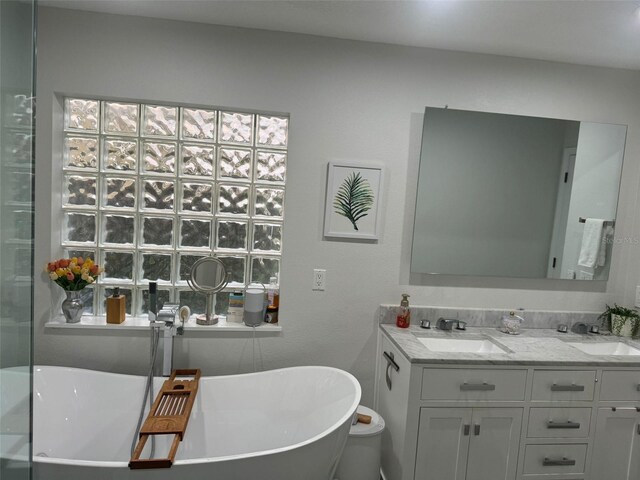 bathroom featuring a tub and vanity