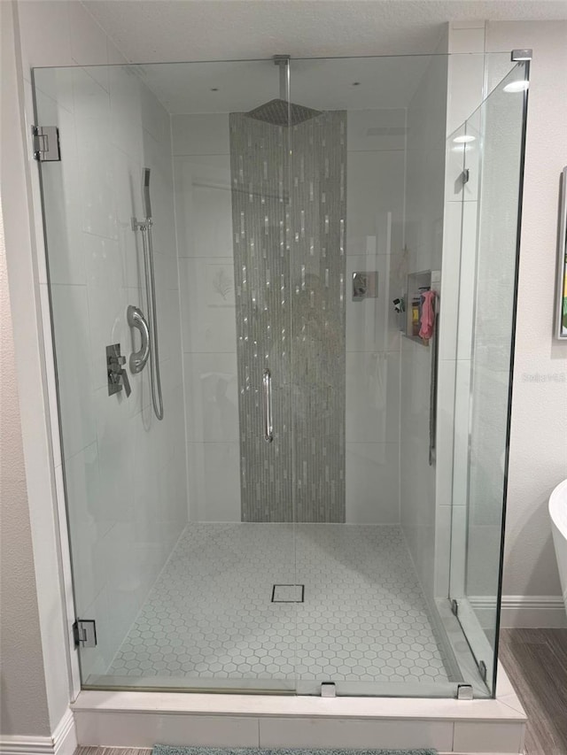 bathroom featuring wood-type flooring and walk in shower