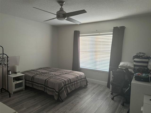 bedroom featuring ceiling fan, a textured ceiling, and hardwood / wood-style flooring