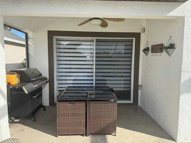 exterior space featuring ceiling fan and a grill