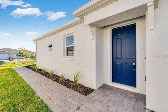 property entrance featuring central AC unit