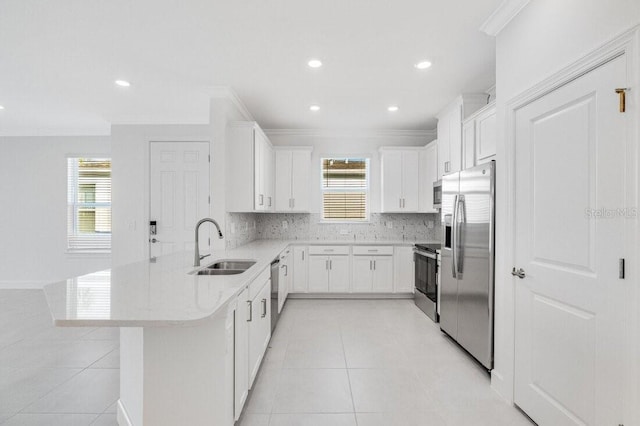 kitchen with white cabinets, crown molding, appliances with stainless steel finishes, and sink