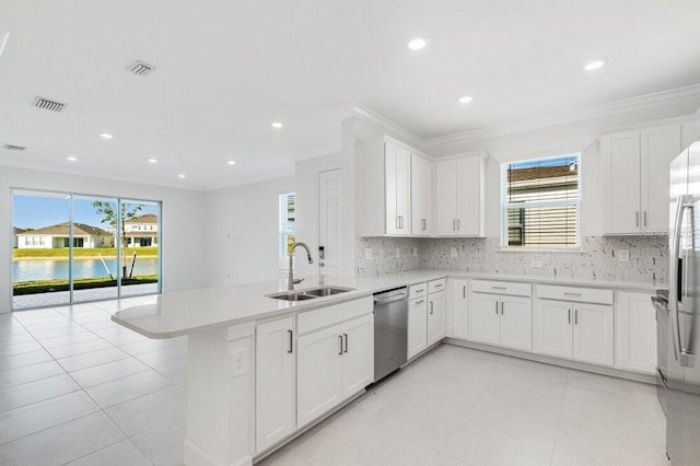 kitchen featuring sink, kitchen peninsula, white cabinets, and dishwasher