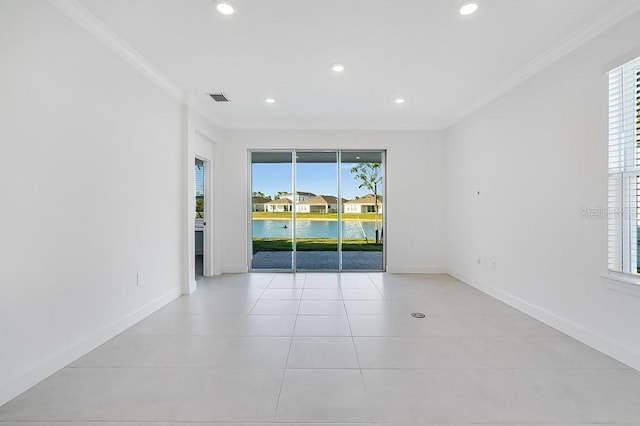 empty room with crown molding, light tile patterned flooring, and a water view