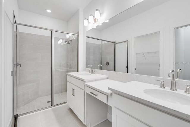 bathroom featuring vanity, tile patterned flooring, and a shower with door