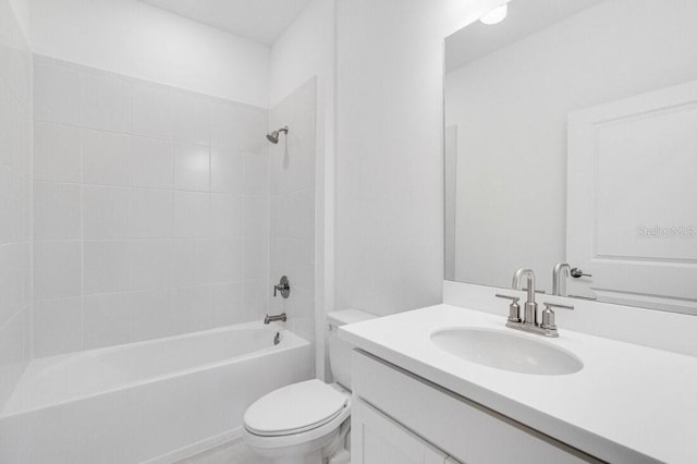 full bathroom featuring toilet, vanity, and tiled shower / bath