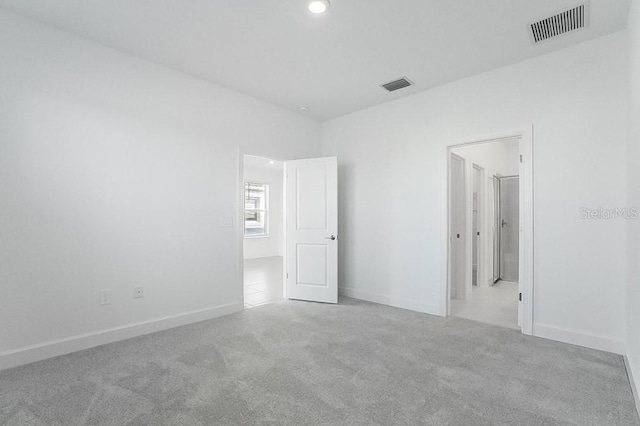 unfurnished bedroom featuring light carpet