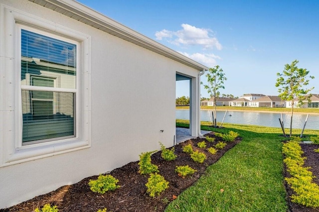 exterior space featuring a yard and a water view