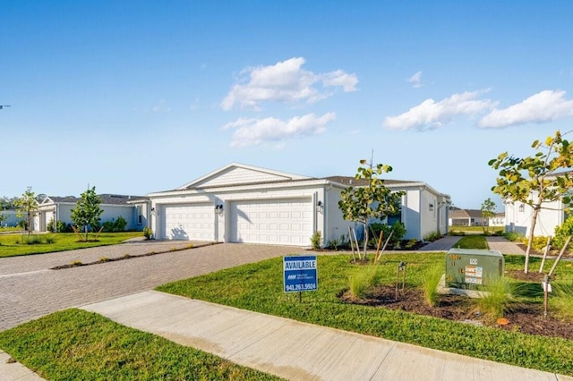 single story home with a front lawn and a garage