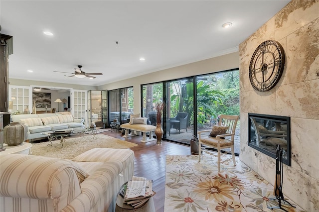 living room with ceiling fan, a fireplace, french doors, and hardwood / wood-style flooring