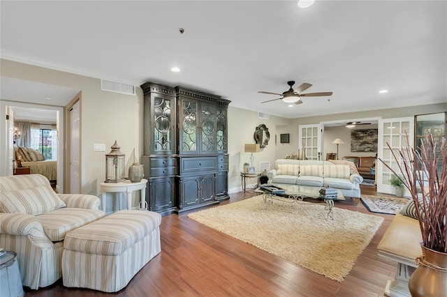 living room featuring wood-type flooring, french doors, ceiling fan, and crown molding