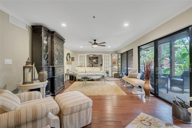 living room with ceiling fan, dark hardwood / wood-style floors, and ornamental molding