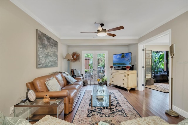 living room with ceiling fan, ornamental molding, dark wood-type flooring, and french doors