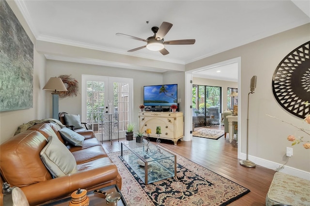 living room featuring french doors, dark hardwood / wood-style flooring, ceiling fan, and ornamental molding