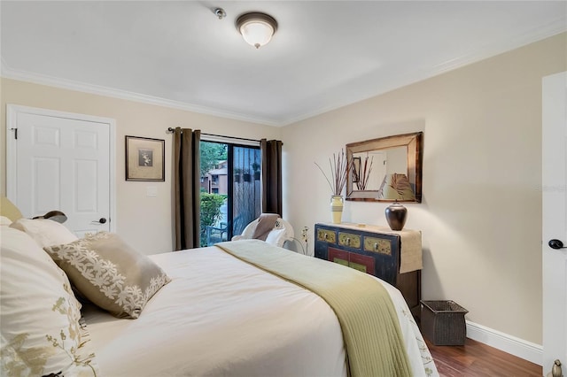 bedroom with ornamental molding and hardwood / wood-style flooring